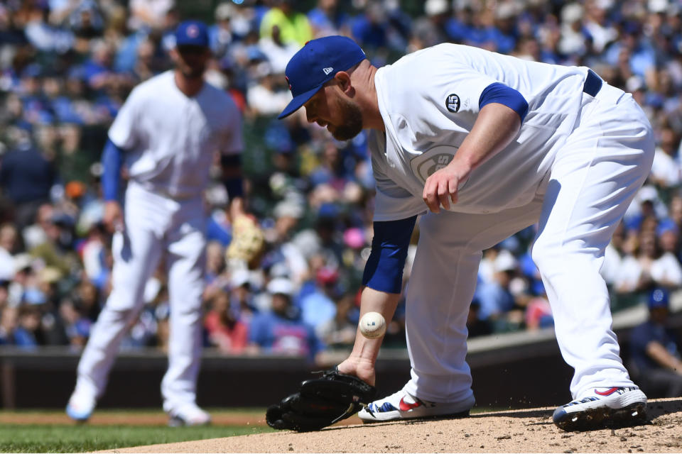 Chicago Cubs starting pitcher Jon Lester (34) makes a fielding error on a bill hit by Washington Nationals Howie Kendrick (47) during the second inning of a baseball game Friday, Aug. 23, 2019, in Chicago. (AP Photo/Matt Marton)