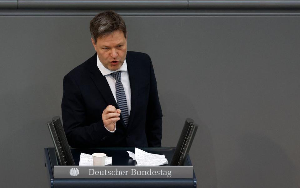 German Minister of Economics and Climate Protection Robert Habeck speaks during an extraordinary session of the Bundestag (lower house of parliament) on February 27, 2022 in Berlin. - Germany on February 26, 2022 dramatically ramped up its backing for Ukraine's battle against Russia, approving weapons deliveries for Kyiv in a policy U-turn and agreeing to limit Moscow's access to the SWIFT interbank system. In a shift from its longstanding policy of banning weapons exports to conflict zones, Berlin is opening up its Bundeswehr store, pledging to transfer 1,000 anti-tank weapons and 500 "Stinger" class surface-to-air missiles to Ukraine. (Photo by Odd ANDERSEN / AFP) (Photo by ODD ANDERSEN/AFP via Getty Images) - ODD ANDERSEN /AFP 