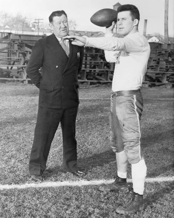 (Original Caption) Jim Thorpe, (L), one of the greatest football players of all time, watches Doug Rehor, a Dickinson College sophomore star, who was leading as small college passer in the country, as the latter practiced for Dickinson’s game with Gettysburg. Thorpe declared, “the boy’s a great passer–a natural.”