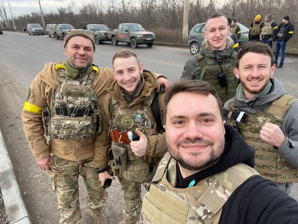 Ivan, far right, with two men from Car4Ukraine, a military chaplain, and a solider near Bakhmut.