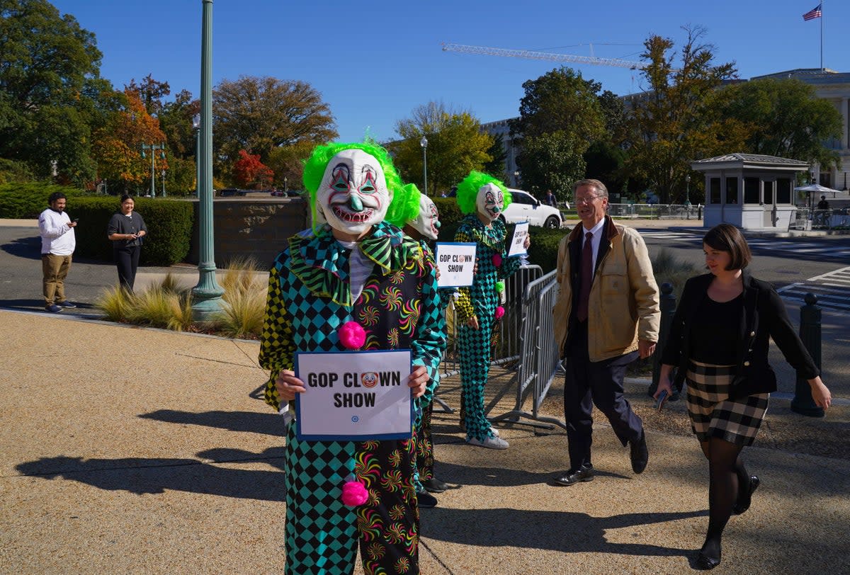 As Rep. Tim Burchett (R-TN) walks toward the U.S. Capitol while the House enters three weeks without a speaker, the Democratic National Committee holds a demonstration comparing the House Republicans' failure to elect a speaker to a "MAGA Clown Show" on Capitol Hill on October 24, 2023 in Washington, DC. (Getty Images for DNC)