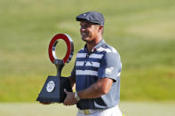 Bryson DeChambeau holds the Rocket Mortgage Classic golf tournament trophy Sunday, July 5, 2020, at Detroit Golf Club in Detroit. DeChambeau won the tournament. (AP Photo/Carlos Osorio)