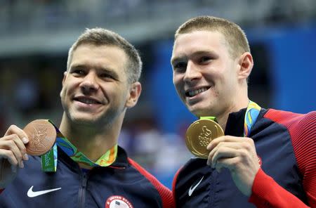 2016 Rio Olympics - Swimming - Victory Ceremony - Men's 100m Backstroke Victory Ceremony - Olympic Aquatics Stadium - Rio de Janeiro, Brazil - 08/08/2016. David Plummer (USA) of USA and teammate Ryan Murphy (USA) pose with their medals. REUTERS/Stefan Wermuth