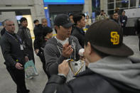 San Diego Padres player Ha-Seong Kim signs an autograph as he arrives at the Incheon International Airport In Incheon, South Korea, Friday, March 15, 2024. (AP Photo/Ahn Young-joon)