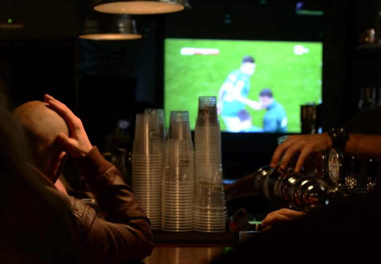 Italian supporters watch the FIFA World Cup 2018 qualification football match Italy vs Sweden TV broadcast at a pub in Rome, on November 13, 2017