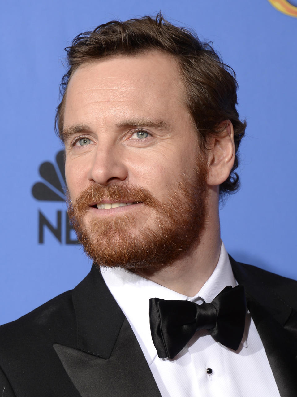 Close-up of Michael in a suit and tie at a media event