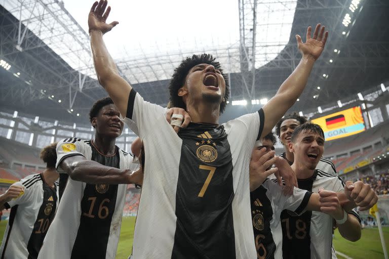 Germany's Paris Brunner, center, celebrates with his teammates after scoring a goal during their FIFA U-17 World Cup quarterfinal soccer match against Spain at Jakarta international Stadium in Jakarta, Indonesia, Friday, Nov. 24, 2023. (AP Photo/Achmad Ibrahim)