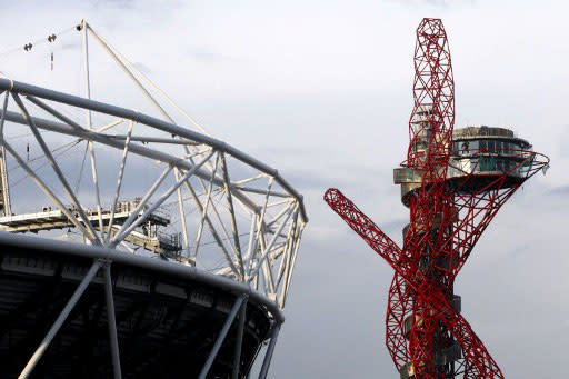 The London 2012 Olympic Stadium (L) seen in the evening next to The Arcelor Mittal Orbit viewing platform at the Olympic Park in Stratford East London on April 12, 2012.. AFP PHOTO / JUSTIN TALLIS