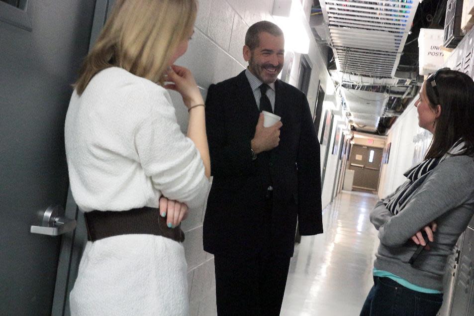 This image released by PBS NewsHour shows science correspondent Miles O'Brien, center, speaking with reporter-producer Rebecca Jacobson, left, and senior online editor Jenny Marder at the WETA production center on Friday, March 7, 2014, in Arlington, Va. O'Brien, who lost part of his arm in an accident while on assignment last February, discussed his injury and amputation with Judy Woodruff on "PBS NewsHour." (AP Photo/PBS Newshour, Joshua Barajas) MANDATORY CREDIT: Joshua Barajas