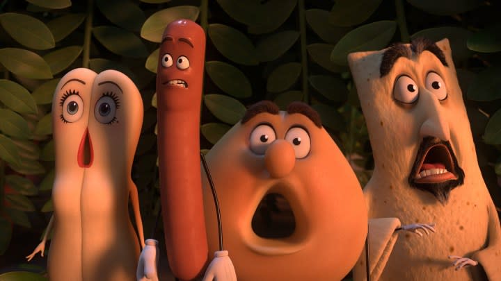 Various anthropomorphic food characters wide eyed and mouthed looking at something in a scene from Sausage Party.