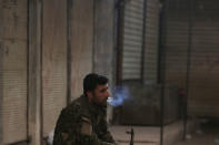 <p>A Syria Democratic Forces (SDF) fighter smokes a cigarette in the city of Manbij, in Aleppo Governorate, Syria, Aug. 10, 2016. (REUTERS/Rodi Said) </p>