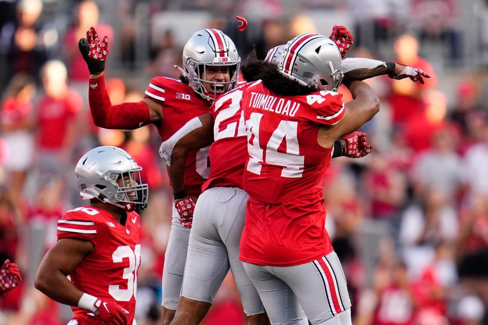 Sep 16, 2023; Columbus, Ohio, USA; Ohio State Buckeyes safety Lathan Ransom (8) and defensive end JT Tuimoloau (44) celebrate an interception by linebacker Steele Chambers (22) during the second half of the NCAA football game against the Western Kentucky Hilltoppers at Ohio Stadium. Ohio State won 63-10.