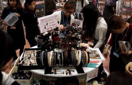 A woman looks at hair accessories displayed at an exhibition and sale during Tokyo Nail Expo 2015 in Tokyo, Japan, November 15, 2015. REUTERS/Yuya Shino