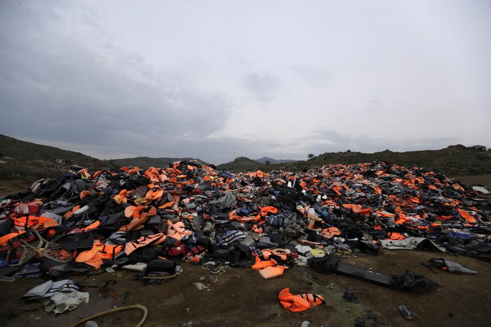 FILE - In this Thursday, March 16, 2017 file photo, piles of life jackets used by refugees and migrants are left in Molyvos village, on the northeastern Greek island of Lesbos. About 1,500 asylum-seekers were being transported from Greece's eastern Aegean island of Lesbos to the mainland Monday Sept. 2, 2019, as part of government efforts to tackle massive overcrowding in refugee camps and a recent spike in the number of people arriving from the nearby Turkish coast. (AP Photo/Thanassis Stavrakis, File)