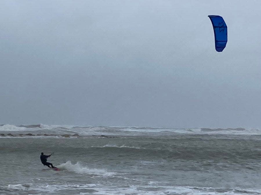 Kite surfers take advantage of high winds and waves ahead of Tropical Storm Nicole on Wednesday morning, Nov. 9, 2022.