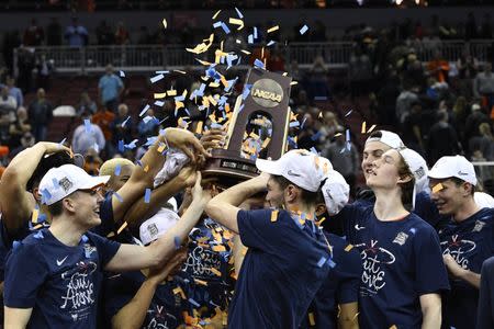 Mar 30, 2019; Louisville, KY, United States; Virginia Cavaliers players lift the trophy during the trophy ceremony after the championship game against the Purdue Boilermakers of the south regional of the 2019 NCAA Tournament at KFC Yum Center. Mandatory Credit: Jamie Rhodes-USA TODAY Sports
