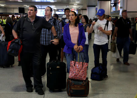 Commuters wait for track announcements at New York's Pennsylvania Station which began track repairs causing massive disruptions to commuters in New York City, U.S., July 10, 2017. REUTERS/Brendan McDermid