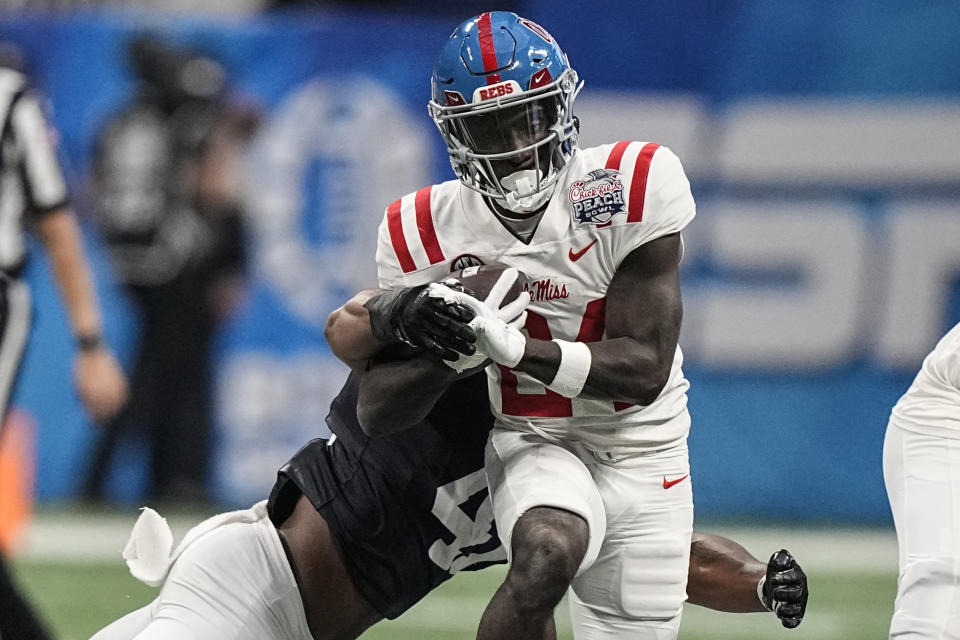 Mississippi running back Ulysses Bentley IV (24) runs against Penn State linebacker Kobe King (41) during the first half of the Peach Bowl NCAA college football game, Saturday, Dec. 30, 2023, in Atlanta. (AP Photo/Brynn Anderson)