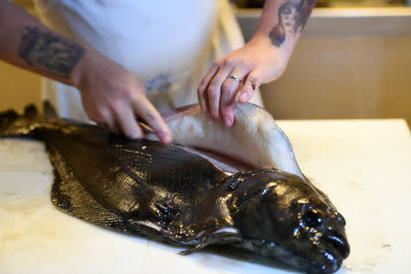 Chef Christopher Haatuft prepares a dish of halibut at his restaurant Lysverket in Bergen, Norway, July 31, 2018. Picture taken July 31, 2018. REUTERS/Clodagh Kilcoyne