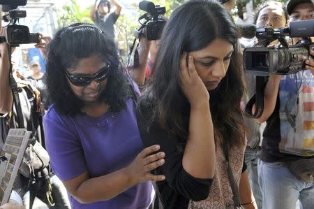 Raji Sukumaran (L), mother of Australian death row prisoner Myuran Sukumaran, is accompanied by her daughter Brintha (R) as they walk past members of the media during a visit with her son outside Kerobokan Prison in Denpasar on the Indonesian island of Bali February 17, 2015 in this picture provided by Antara Foto.