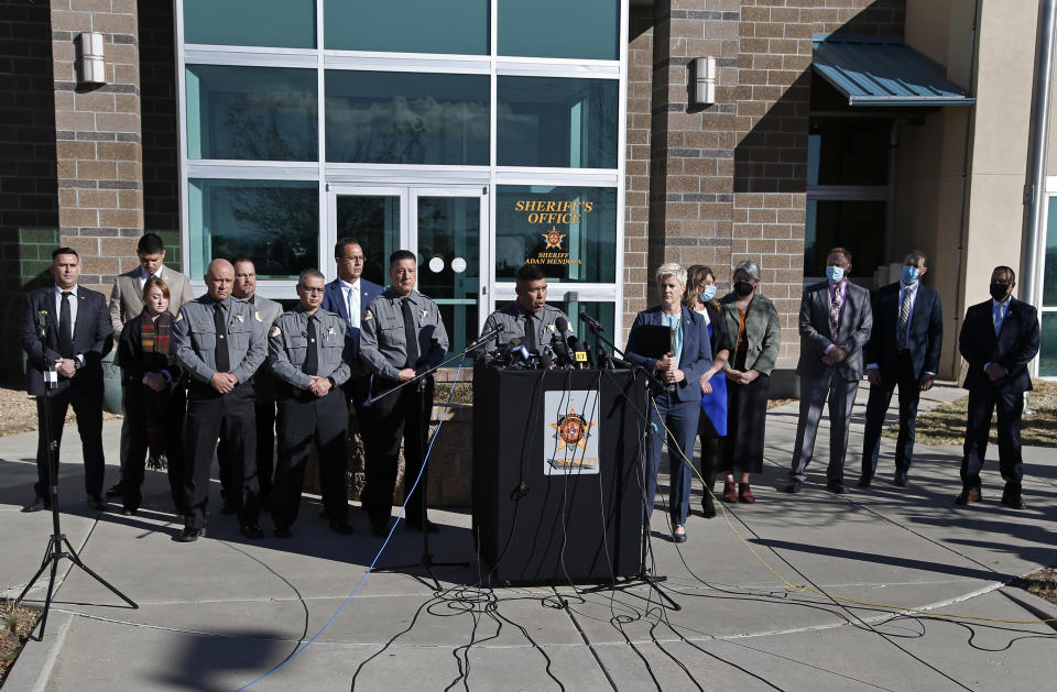 Santa Fe County Sheriff Adan Mendoza, center left, and Santa Fe District Attorney Mary Carmack-Altwies, center right, attend a news conference in Santa Fe, N.M. Wednesday, Oct. 27, 2021. New Mexico authorities said Wednesday they have recovered a lead projectile believed to have been fired from the gun used in the fatal movie-set shooting. (AP Photo/Andres Leighton)