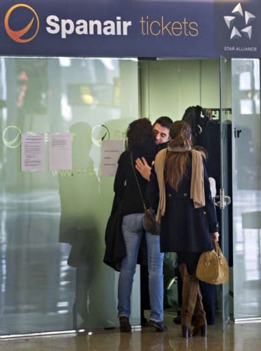 Spanair's employees hug each other at the Son Sant Joan airport in Palma de Mallorca. Spanair filed for voluntary bankruptcy Monday, officials said, three days after abruptly stopping all flights and stranding tens of thousands of passengers