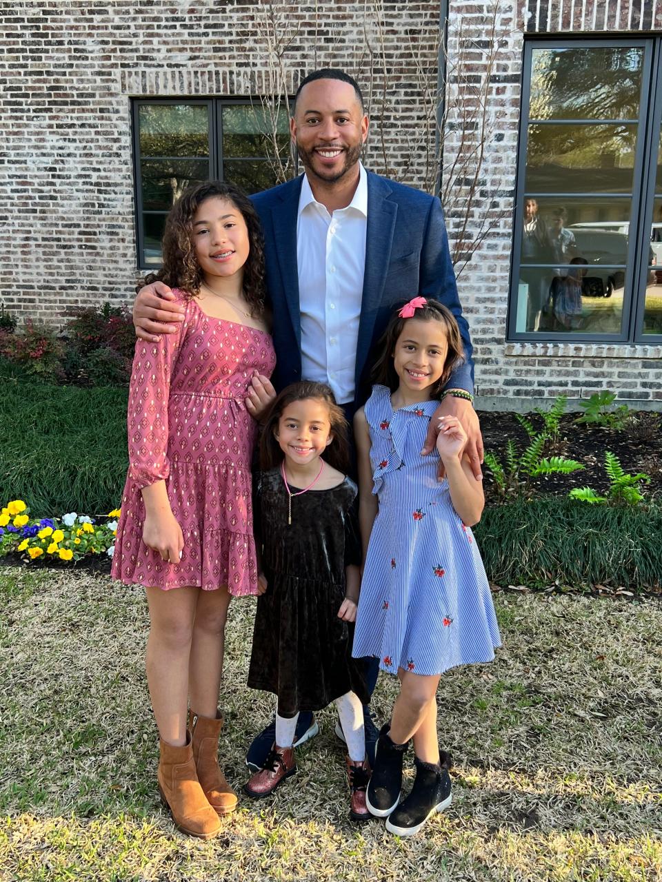 Former Wisconsin basketball star Devin Harris poses for a photo with his three daughters in Texas.