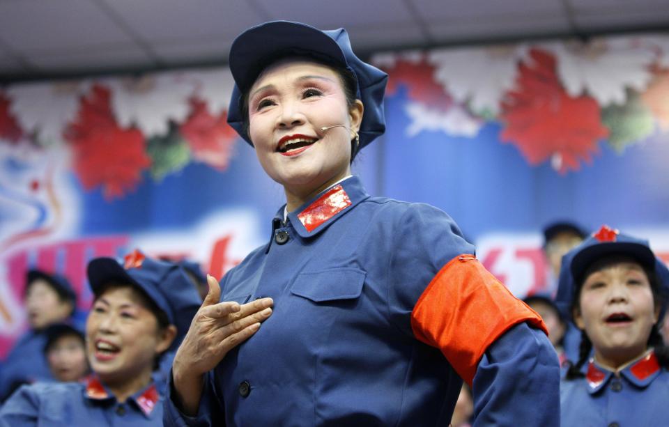 Retired female workers dressed as red army soldiers sing revolutionary songs during a performance to mark the 120th birth anniversary of Chinese late Chairman Mao Zedong in Huaibei