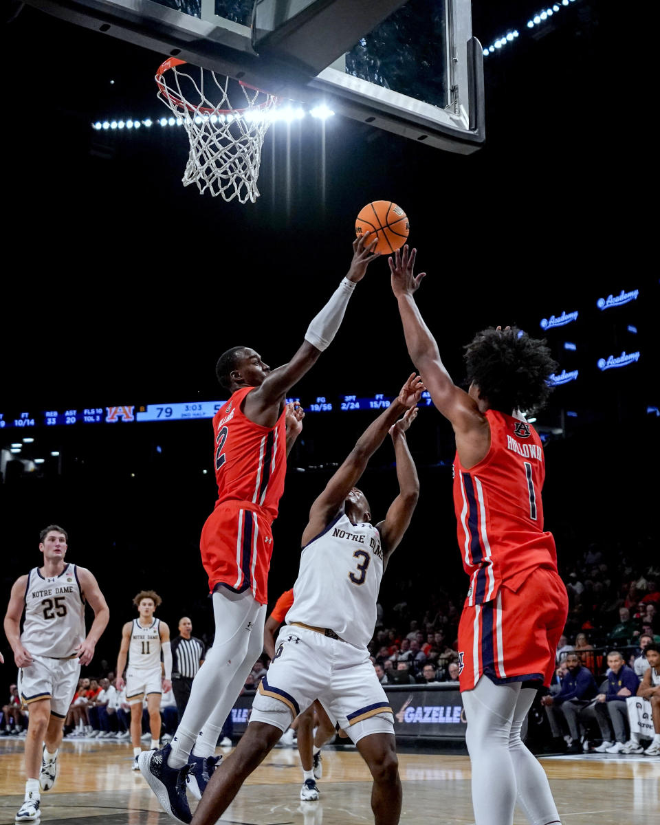 Auburn forward Jaylin Williams (2) blocks the shot of Notre Dame guard Markus Burton (3) during the second half of an NCAA college basketball game in the Legends Classic tournament in New York, Thursday, Nov. 16, 2023. (AP Photo/Peter K. Afriyie)