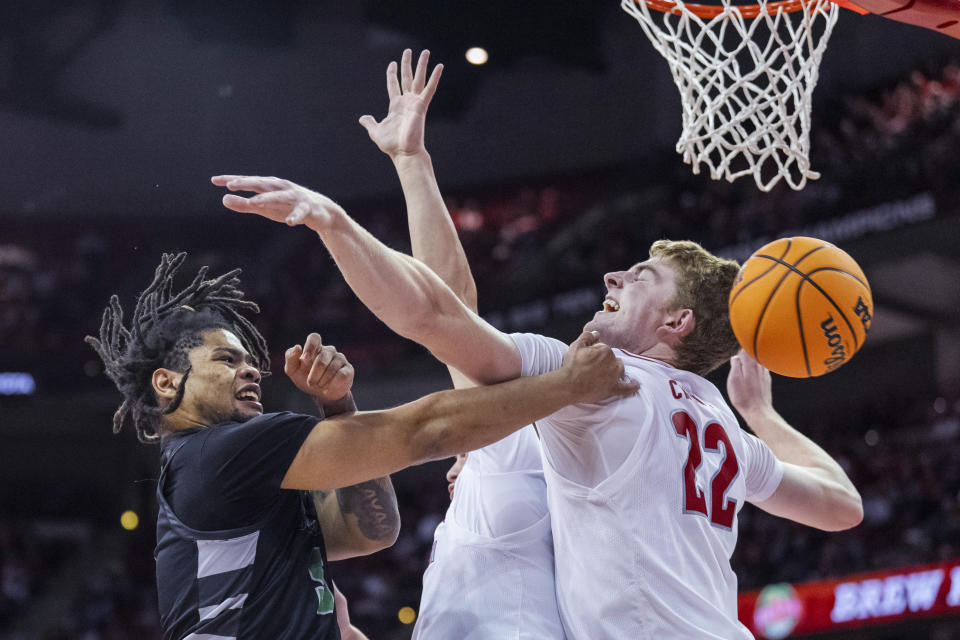 Chicago State's Kedrick Green (5) passes the ball past Wisconsin's Steven Crowl (22) during the first half of an NCAA college basketball game Friday, Dec. 22, 2023, in Madison, Wis. (AP Photo/Andy Manis)