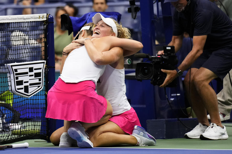 Erin Routliffe, of New Zealand, right, hugs Gabriela Dabrowski, of Canada, after winning the women's doubles final of the U.S. Open tennis championships against Laura Siegemund, of Germany, and Vera Zvonareva, of Russia, Sunday, Sept. 10, 2023, in New York. (AP Photo/Manu Fernandez)