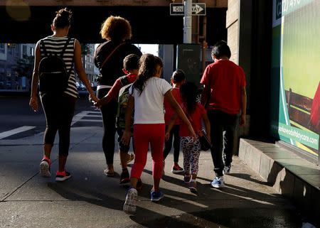 Children are escorted to the Cayuga Center, which provides foster care and other services to immigrant children separated from their families, in New York City, U.S., July 10, 2018. REUTERS/Brendan McDermid