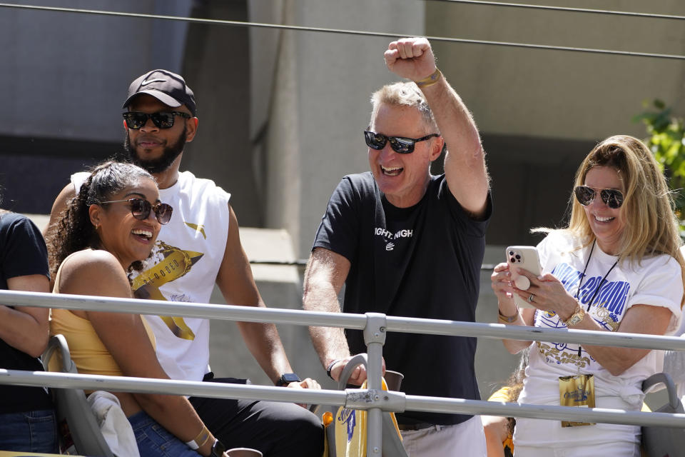 Golden State Warriors head coach Steve Kerr raises a fist while riding in their NBA championship parade in San Francisco, Monday, June 20, 2022. (AP Photo/Eric Risberg)