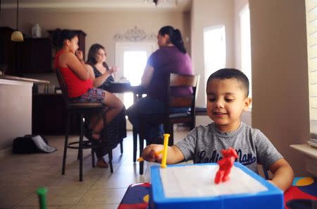 Kane plays with a toy at the home of his family in El Paso, Texas, U.S. on July 2, 2016. Kane's mother, Natalie Silva, contracted Methicillin-resistant Staphylococcus aureus, more commonly known as MRSA, a skin infection that can turn fatal once it enters the bloodstream, when she went to the hospital to give birth to Kane. After a 10 month battle with MRSA, Silva died, and her sisters have come together to raise her two children. REUTERS/Dan Dalstra