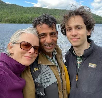 Hisham Awartani, right, with his father, Ali, and mom, Elizabeth Price, on a family trip to New England.