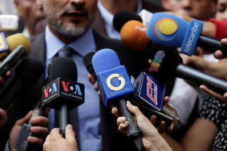 The logo of Globovision TV channel is seen on a microphone (C) used by a TV journalist among other microphones during a news conference in Caracas, Venezuela May 16, 2017. Picture taken May 16, 2017. REUTERS/Marco Bello