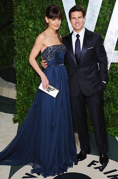 <b>Katie Holmes & Tom Cruise</b><br><br>The former Mrs. Cruise's fashion transformation from single gal to A-list ball-and-chain is the stuff of legends (remember that chic little newlywed bob?) and Tom was there to help with the makeover. Here at the 2012 Vanity Fair Oscar Party - one of their last public outings together - he coordinated his tailored blue-hued suit to match Katie's gorgeous navy gown.