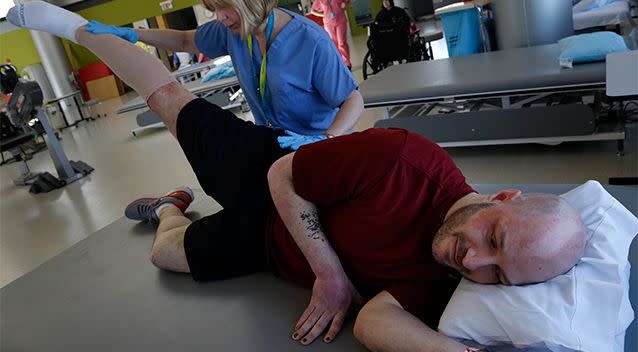 Boston Marathon bombing victim James Costello is stretched by Physical Therapist Lisa Pratt at Spaulding Rehabilitation Hospital in Boston. Photo: AP