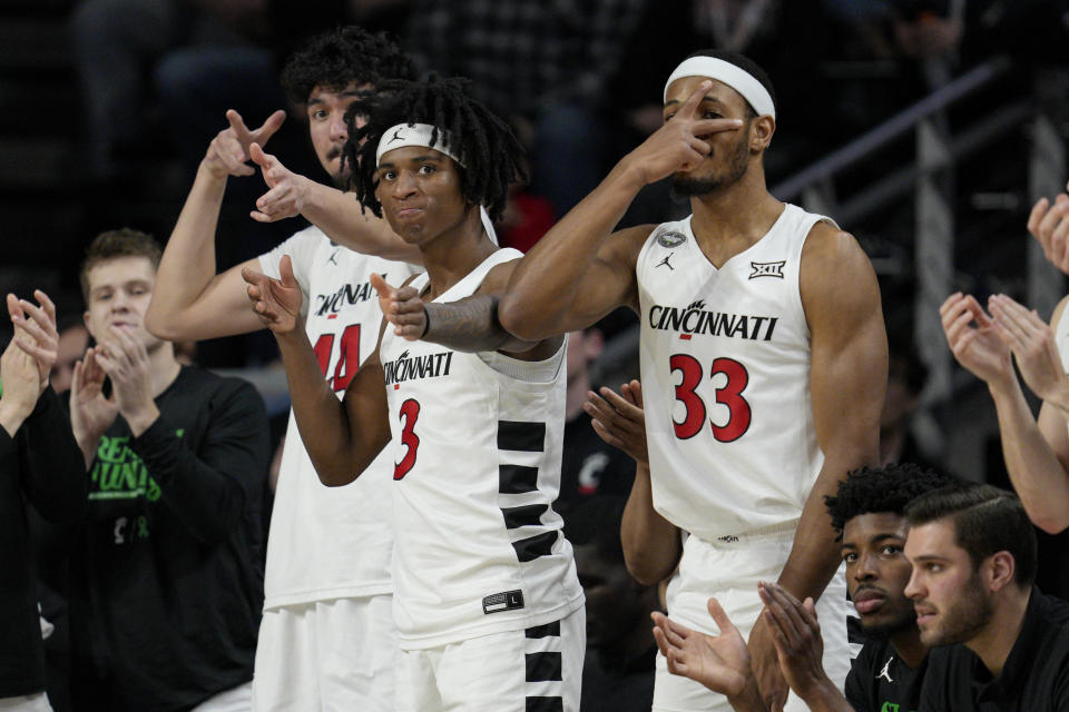 The Cincinnati bench reacts to a three-point basket by Dan Skillings Jr. during the second half of an NCAA college basketball game against Iowa State, Tuesday, Feb. 13, 2024, in Cincinnati. (AP Photo/Jeff Dean)