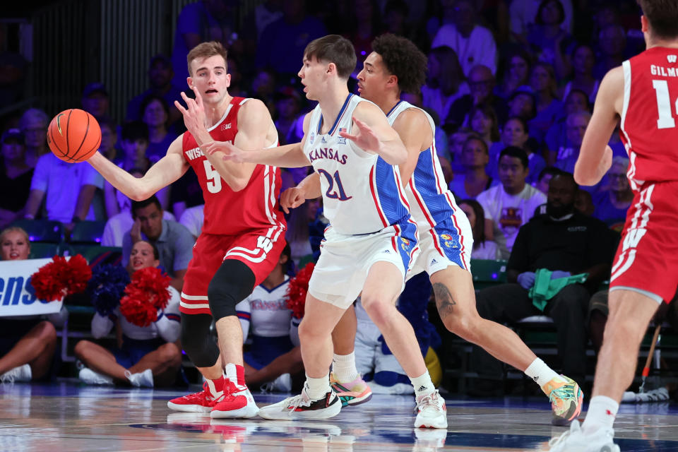 In a photo provided by Bahamas Visual Services, Wisconsin's Tyler Wahl (5) passes the ball during an NCAA college basketball game against Kansas in the Battle 4 Atlantis at Paradise Island, Bahamas, Thursday, Nov. 24, 2022. (Tim Aylen/Bahamas Visual Services via AP)