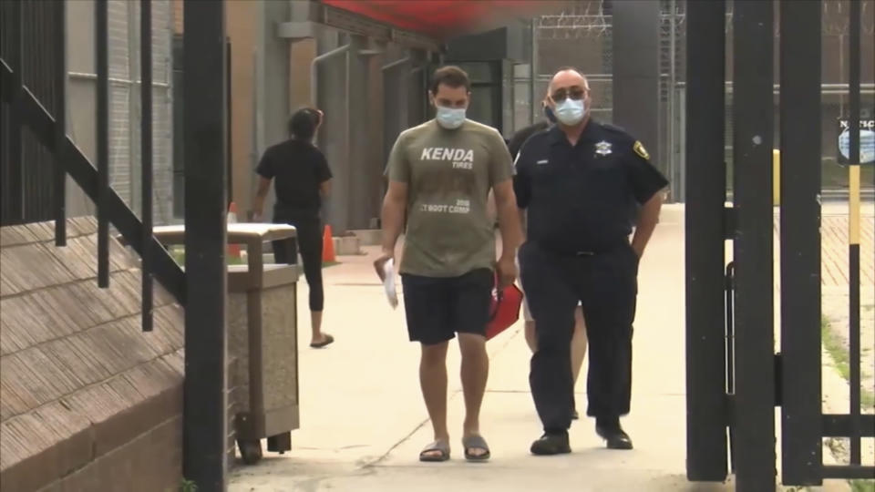 In this screen grab from ABC7, Keegan Casteel leaves jail at the 18th District police headquarters in Chicago July 27, 2021. Keegan, of Ankeny, Iowa, was in custody in Chicago after police found a rifle with a laser sight in a hotel room that overlooks a Lake Michigan beach during the July Fourth weekend. Soon after, he proposed to his girlfriend and she appeared to accept. (ABC7 via AP)