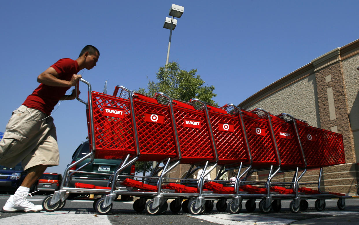 A worker collects shopping carts at a Target store in Falls Church, Virginia August 19, 2008. Target Corp reported a nearly 8 percent drop in quarterly profit on Tuesday as shoppers passed over trendy clothes and home decor in favor of everyday necessities, hurting its margins. REUTERS/Kevin Lamarque   (UNITED STATES)