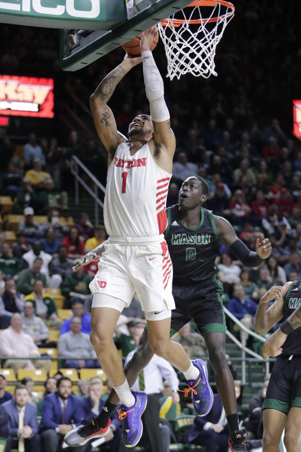 Dayton's Obi Toppin (1) shoots the ball as George Mason's Goanar Mar, right, defends during the first half of an NCAA college basketball game Tuesday, Feb. 25, 2020, in Fairfax, Va.(AP Photo/Luis M. Alvarez)