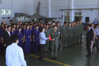 Taiwan President Tsai Ing-wen, center left, poses for photos with airmen near a Taiwan Indigenous Defense Fighter (IDF) jet displayed during a visit to the Penghu Magong military air base in outlying Penghu Island, Taiwan Tuesday, Sept. 22, 2020. Tsai visited the military base on one of Taiwan’s outlying islands Tuesday in a display of resolve following a recent show of force by rival China. (AP Photo/Johnson Lai)