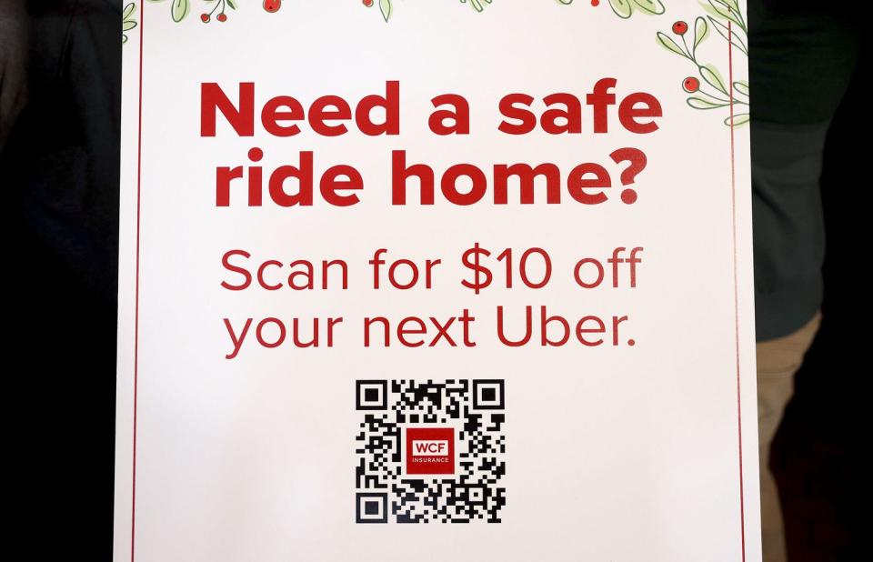 A QR code is displayed on a sign inside Bar X during a press conference urging drivers to add a sober ride to their winter holiday plans in Salt Lake City on Thursday. WCF Insurance is sponsoring the $10 Uber ride credit.