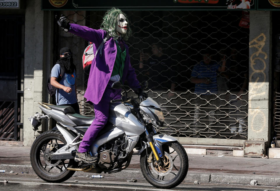 A protester dressed as a joker rides a motocycle during a protest against Chile's government in Valparaiso, Chile on Oct. 28, 2019. (Photo: Rodrigo Garrido/Reuters)