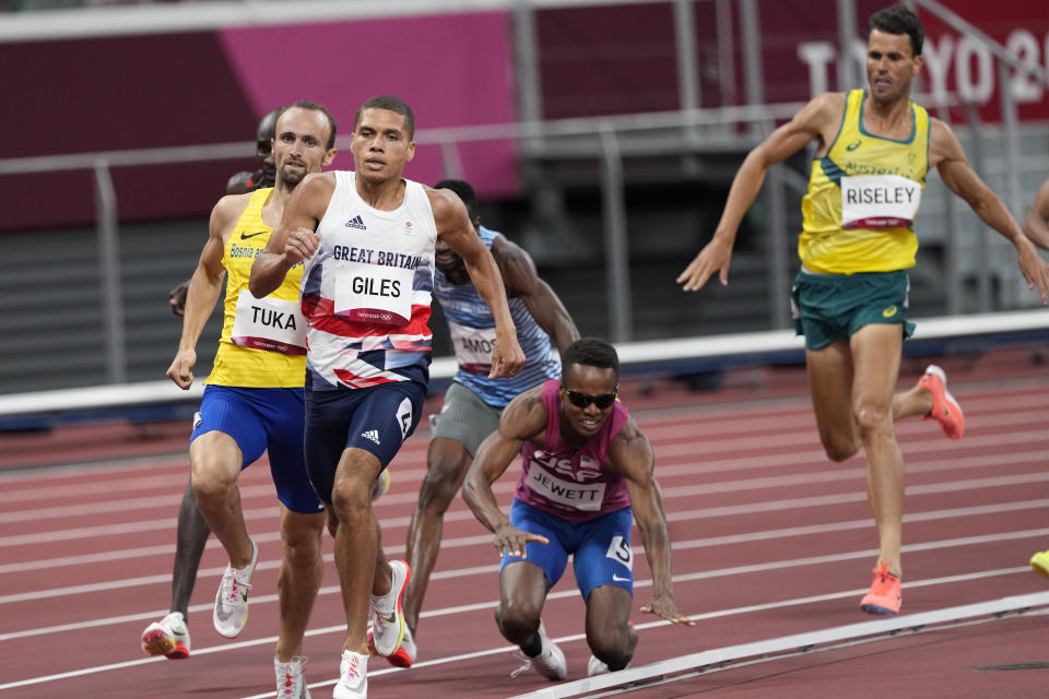 Isaiah Jewett, of United the States, and Nijel Amos, of Botswana, fall in the men's 800-meter semifinal at the 2020 Summer Olympics, Sunday, Aug. 1, 2021, in Tokyo.(AP Photo/Jae C. Hong)