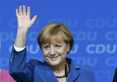 German Chancellor and leader of Christian Democratic Union (CDU) Angela Merkel waves to supporters after first exit polls in the German general election (Bundestagswahl) at the CDU party headquarters in Berlin September 22, 2013. REUTERS/Fabrizio Bensch