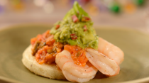 Arepa topped with Shrimp, Crushed Avocado Aji and Tomato Sauce. (Disney)