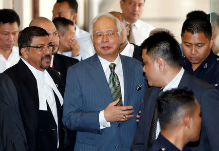 FILE PHOTO: Malaysia's former prime minister Najib Razak walks out of a courtroom in Kuala Lumpur, Malaysia August 8, 2018. REUTERS/Lai Seng Sin/File Photo